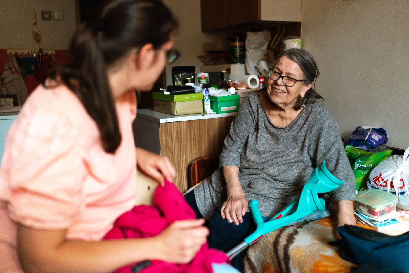 A caregiver chatting warmly with a senior