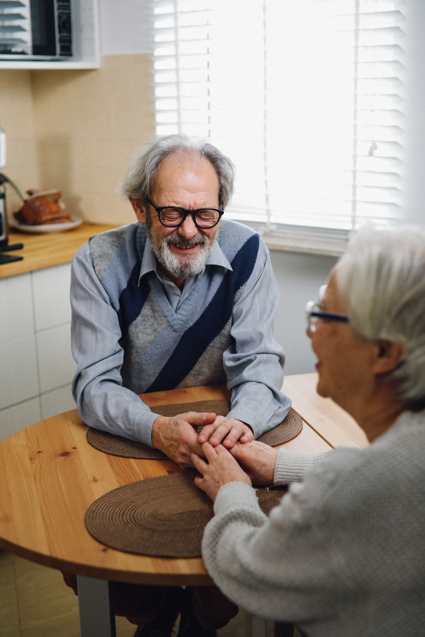 A senior couple smiling together at home